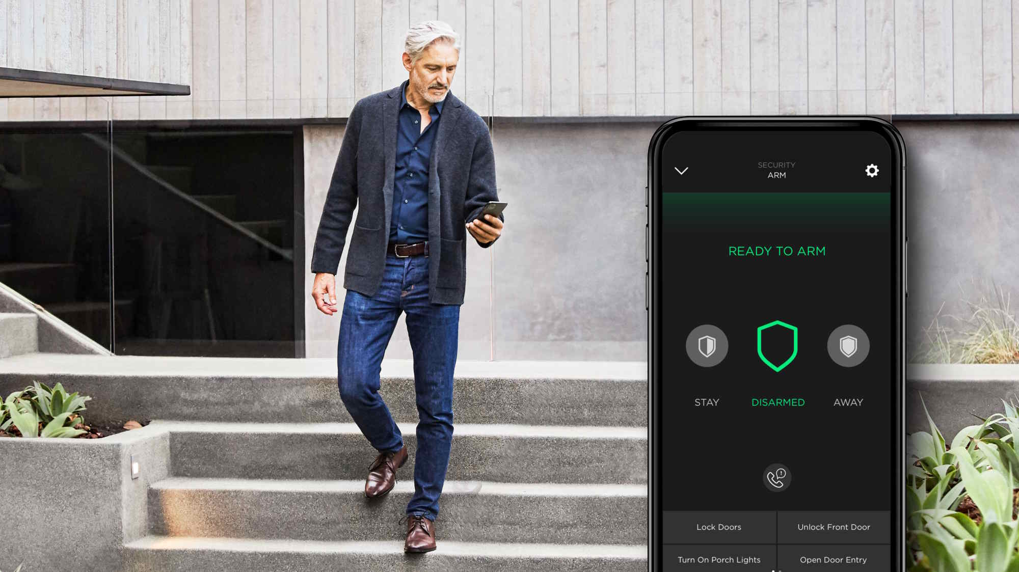 Man walking down the concrete steps of a modern home while checking his smartphone, with an overlaid security app screen showing ‘Ready to Arm,’ status ‘Disarmed,’ and quick actions like lock/unlock doors and turn on porch lights.