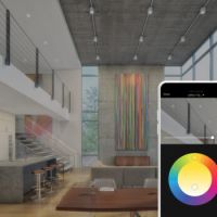 A modern home with an open floor plan, and an overlayed smartphone displaying the Savant App lighting wheel.