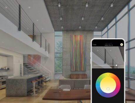 A modern home with an open floor plan, and an overlayed smartphone displaying the Savant App lighting wheel.