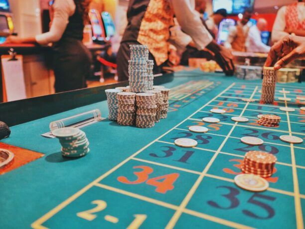 A casino table showing the ambiance of the business in the background.