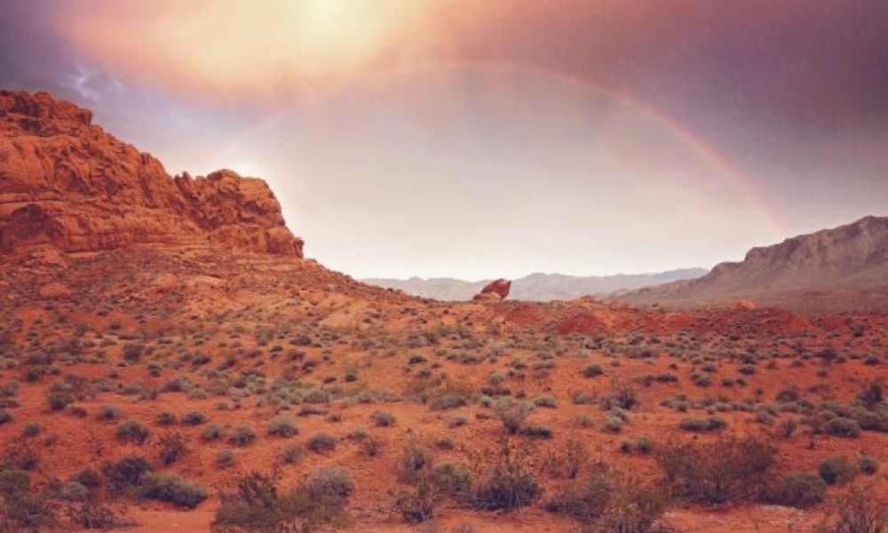 <span class="uk-h4">A rainbow and sunlight over a desert.</span>