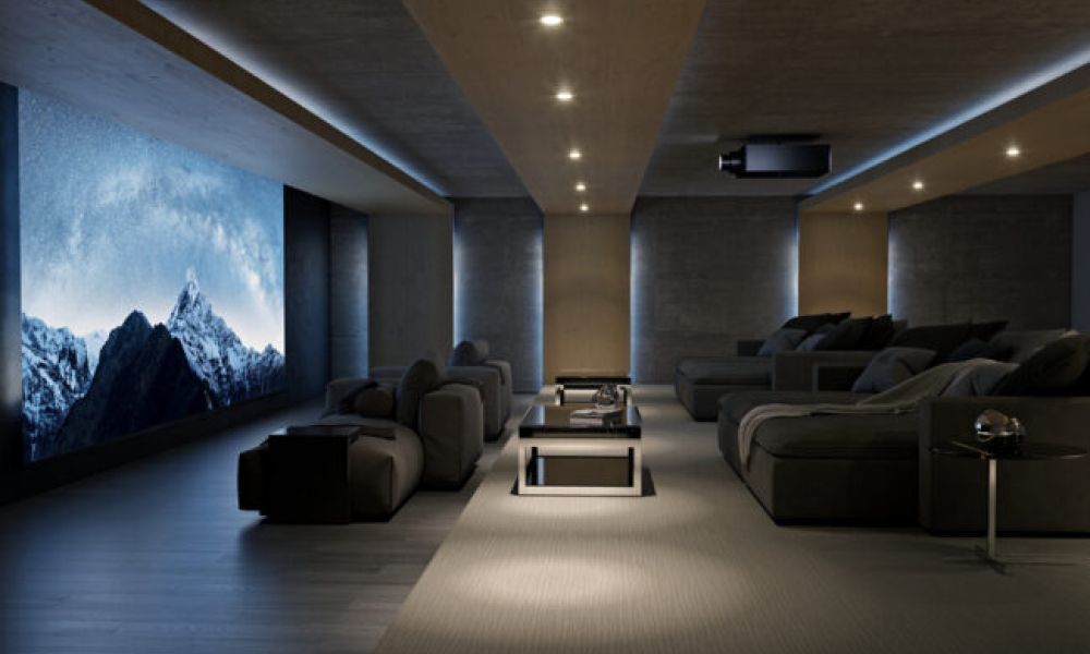 <span class="uk-h4">A home theater with a large movie screen depicting snow-capped mountains, a Sony projector, and chaise lounges.</span>