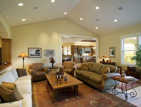 A living room in neutral colors with in-ceiling speakers