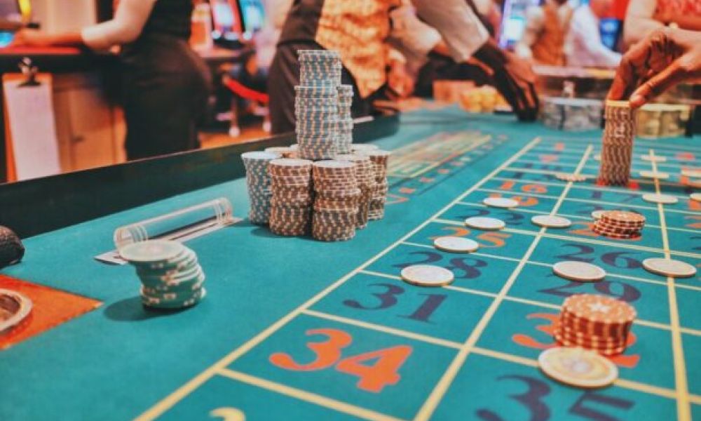 <span class="uk-h4">A casino table showing the ambiance of the business in the background.</span>