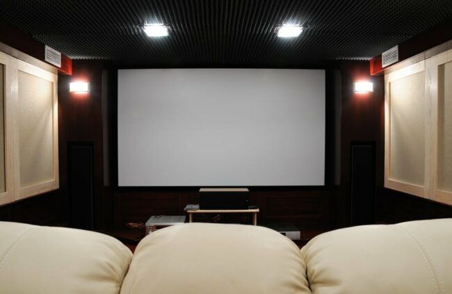 A private home theater setup featuring a large screen and seating