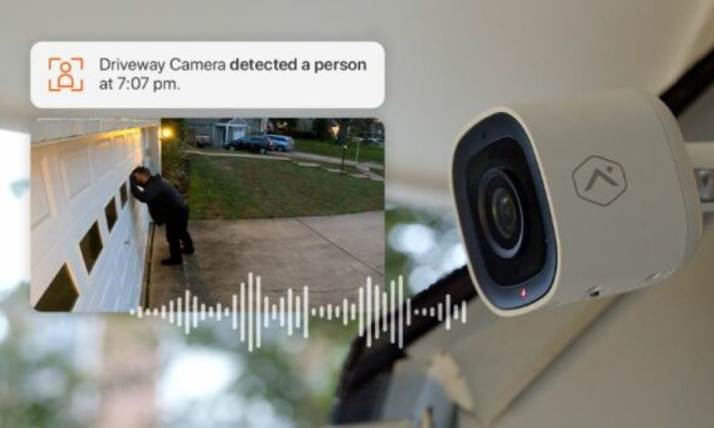 <span class="uk-h4">An Alarm.com security camera sending a notification showing a person looking into a garage.</span>