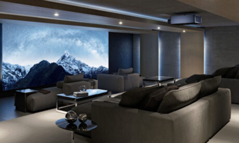 <span class="uk-h4">A home theater with chaise lounges, a Sony projector, and a large movie screen.</span>